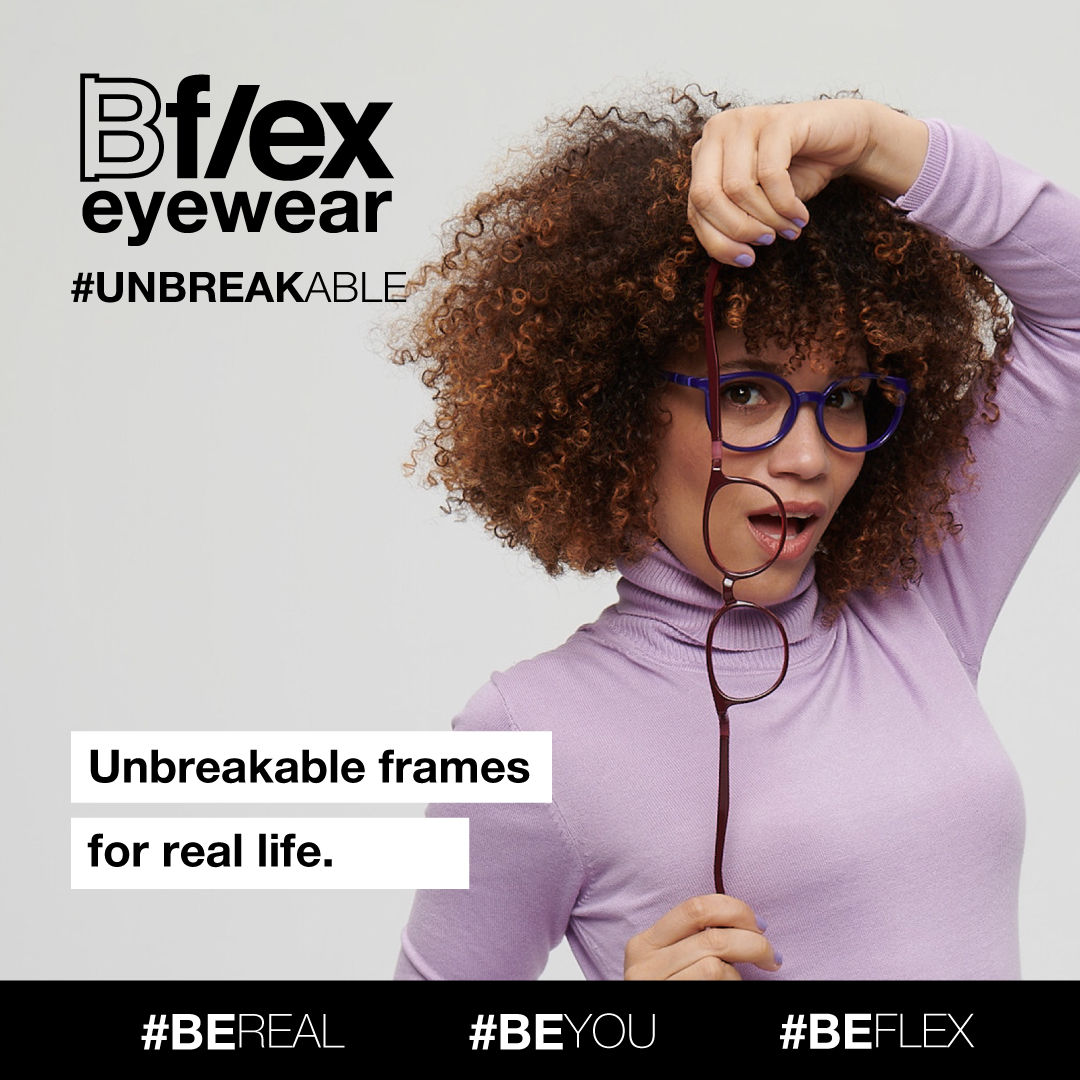 A woman with dark curly hair, wearing a long-sleeved lilac turtle-neck, models thick blue frames, holding and stretching a pair of thick dark purple frames. Bflex Eyewear logo is in the upper left of the image.