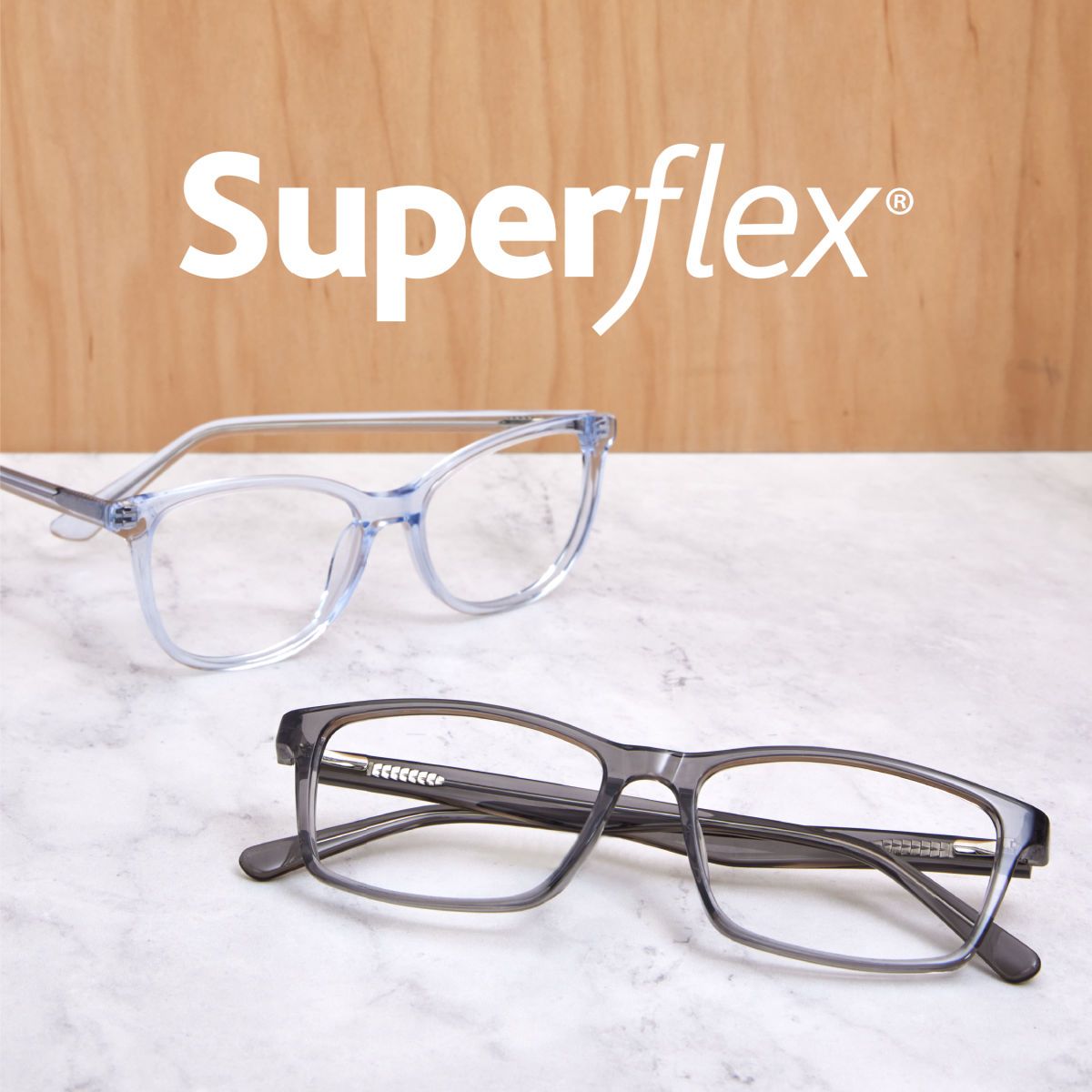 Two pairs of glasses on a marble counter below Superflex logo