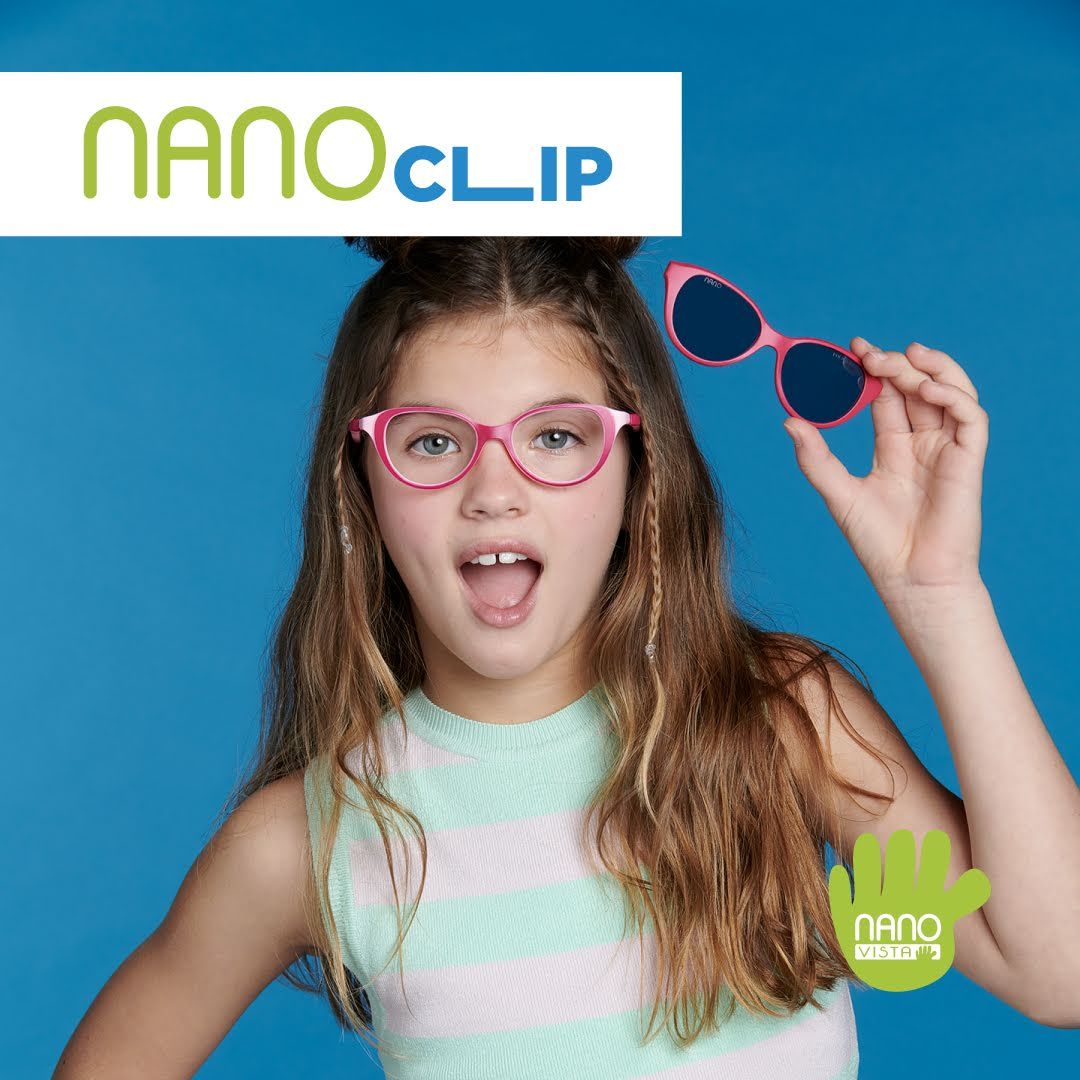 Young girl wih long brown hair and horizontally striped tanktop stands against a blue background wearing pink cat-eye frames, looking shocked and holding up matching sunglass clip-on frames. Nano Clip logo located in the upper left, Nano Vista logo located on bottom right.
