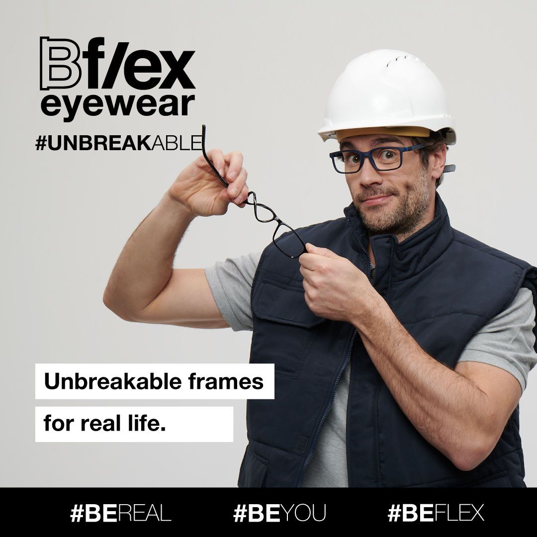 A male construction worker with a blue vest and matching thick dark blue frames, holds and twists a par of dark frames. Bflex Eyewear logo is in the upper left of the image.