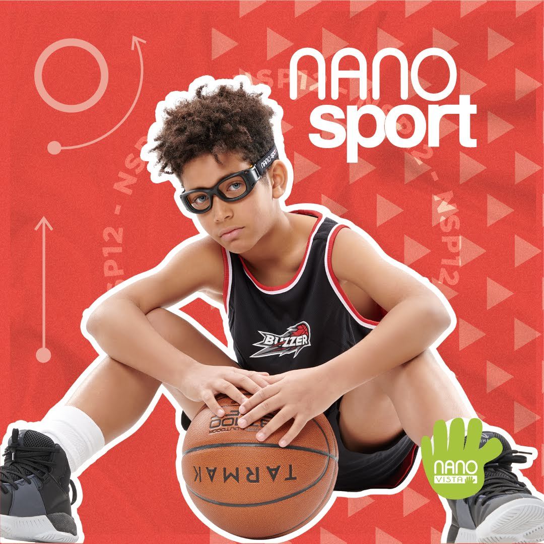 African American boy in a black basket ball uniform, sitting with his hands on a basketball wearing thick black frames straped around his head, against a busy red background. Nano Sport logo in the upper right.