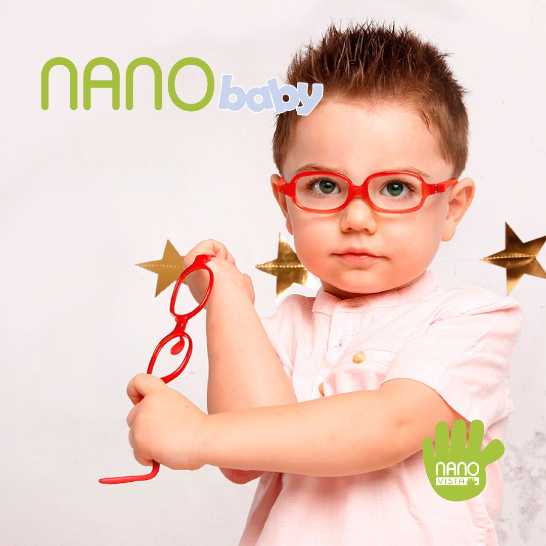 Young boy in with brown spikey hair and a white short sleeved shirt, standing in front of 3 golden stars, and wearing brigh ready frames, holding and twisting another pair of red frames. Nano Baby logo located in the upper left, Nano Vista logo located on bottom right.