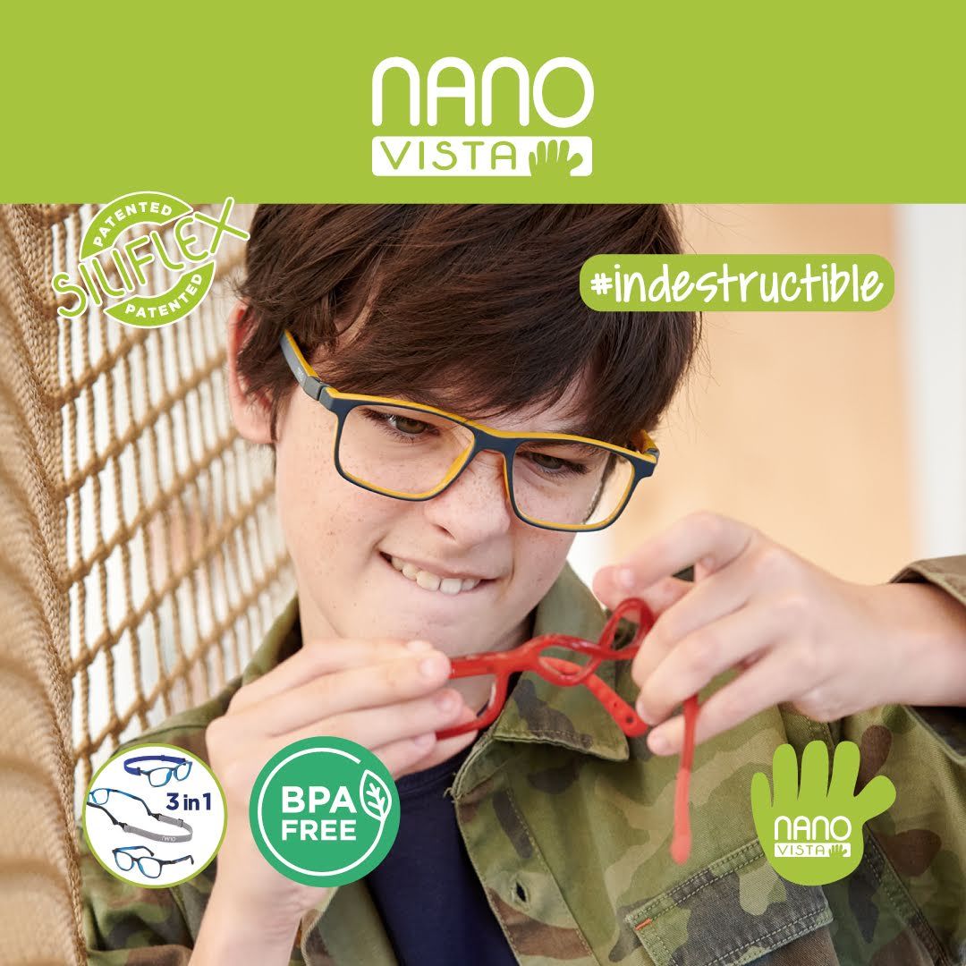 Boy with short brown hair wearing a camo jacket and black and yellow frames, leans against netting while focusing on twisting a pair of red frames. Nano Vista Logo across the top and in the bottom right of image.